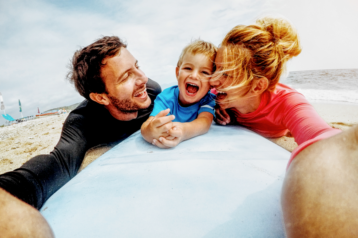 Lachende Familie am Strand bearbeitet