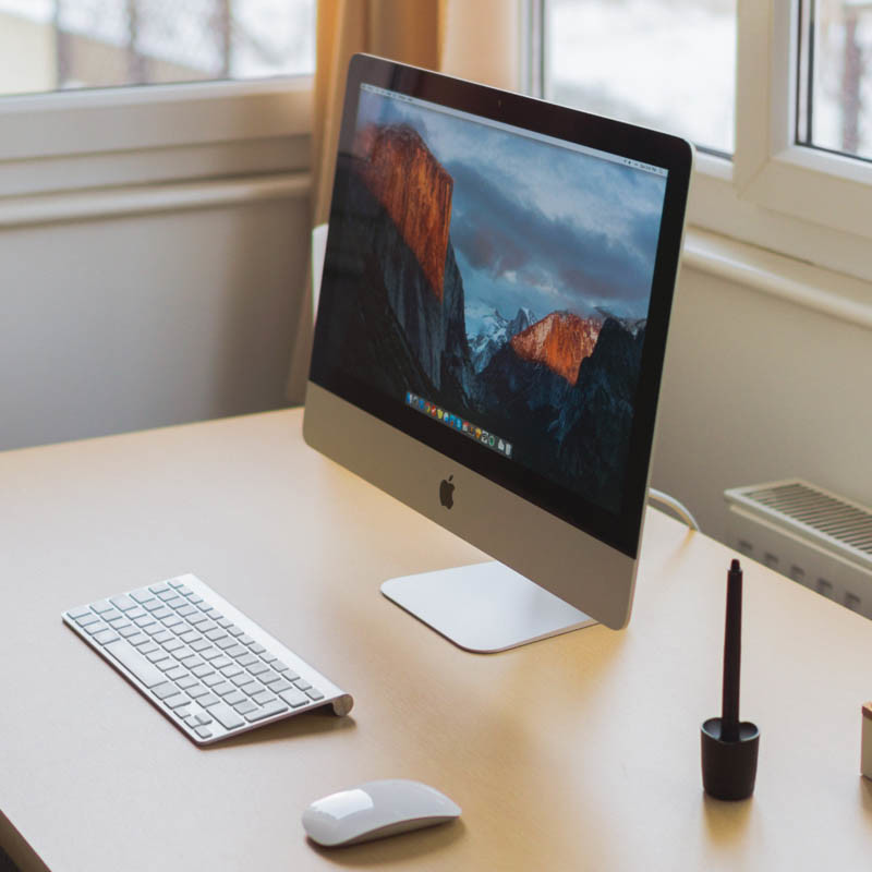 Schreibtisch mit Monitor, Tastatur und Maus